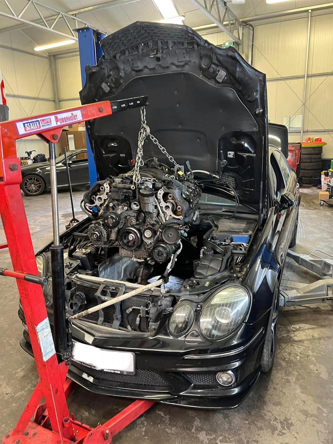 Mercedes E63 AMG V8 being removed for strip-down and rebuild